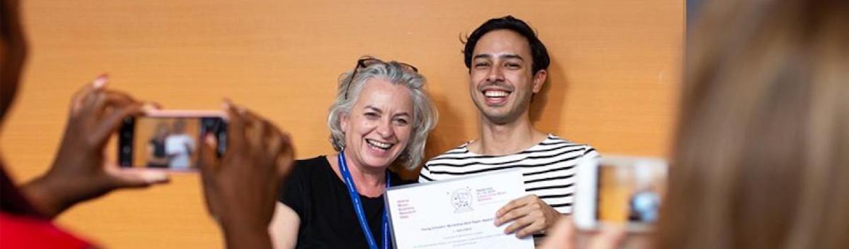 student-receiving-award-at-young-scholars-workshop